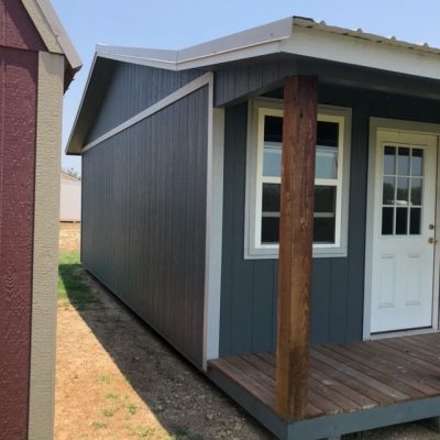 A 14x28 Cottage Shed with a porch on the side for sale near me.