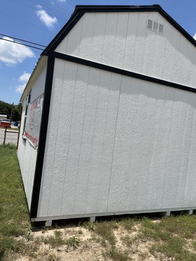A 12x24 Lofted Barn shed with a black roof available for sale.