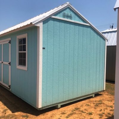 A blue and white 10x20 Garden Shed for sale sitting on a dirt lot.