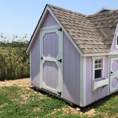 An 8x12 Victorian Playhouse with a blue roof available for sale at the shed store near me.