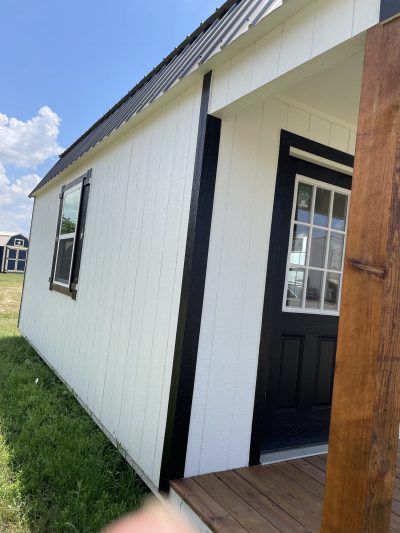 A 12x24 Lofted Barn with a wooden porch available for purchase.