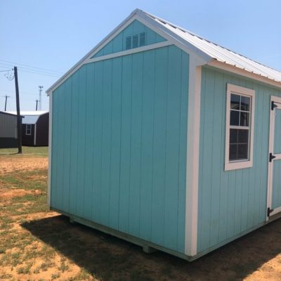 A blue and white 10x20 Garden Shed for sale, sitting on a dirt lot near me at the shed store.