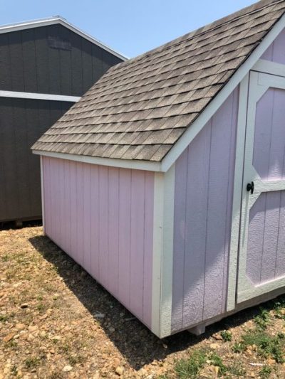 Two 8x12 Victorian Playhouse for sale in a yard.