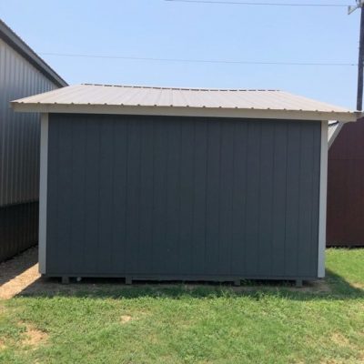 A 14x28 Cottage Shed for sale in a grassy area.