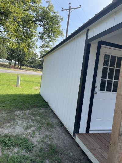 For sale 10x24 Cabinette Shed - A small white shed with a door on the side is available for purchase.