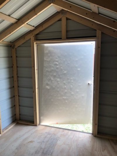For sale 8x10 Metal Shed: The inside of an 8x10 Metal Shed with a door open, perfect for those looking to buy an 8x10 Metal Shed.