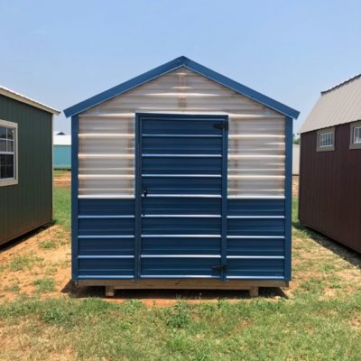 An 8x16 Greenhouse Shed for sale sitting in a field.