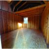 A 12x16 Lofted Barn Shed with wood flooring and plywood walls.